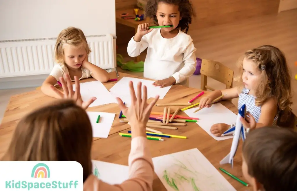 A picture of a teacher teaching her four pupils how to count