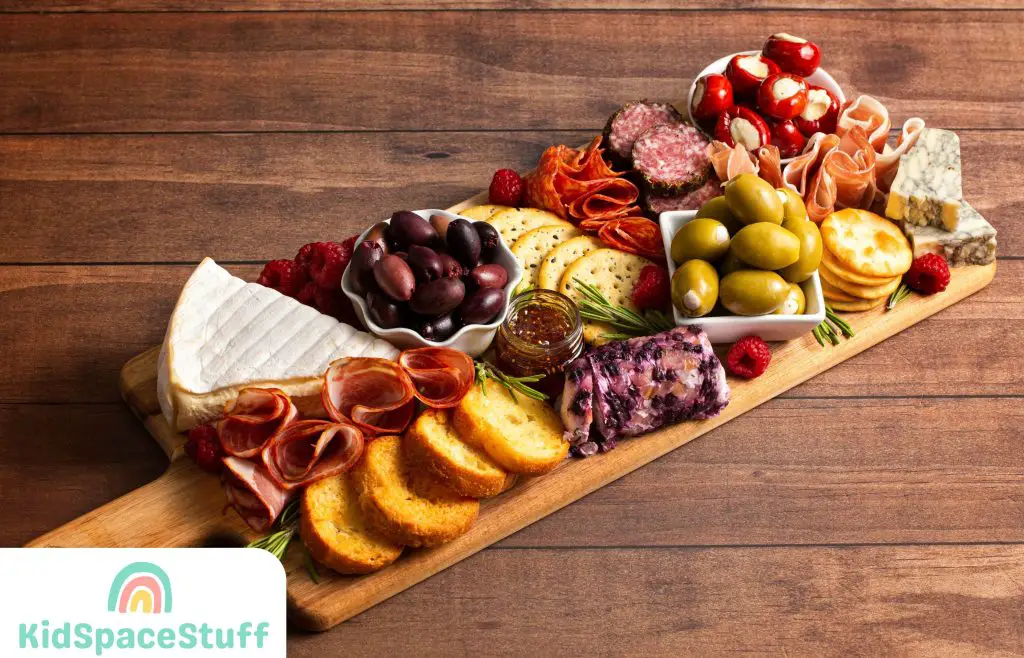 Savoury Charcuterie Board Covered in Meats Olives Peppers Berries and Cheese