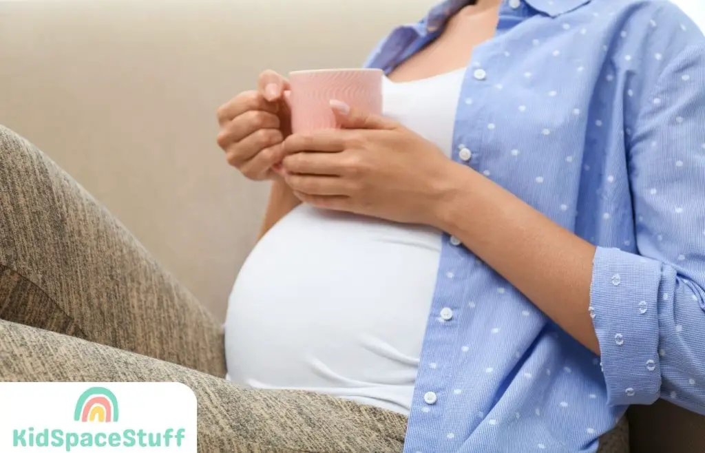 A pregnant woman is drinking chai tea.