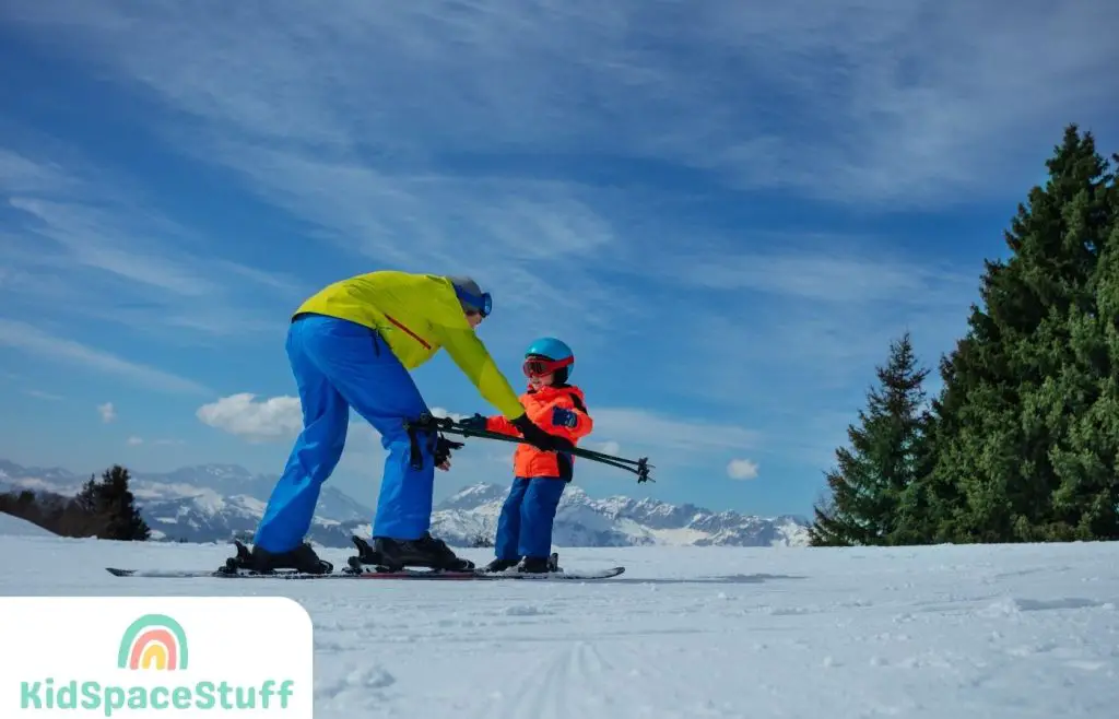 Dad shows child how to ski